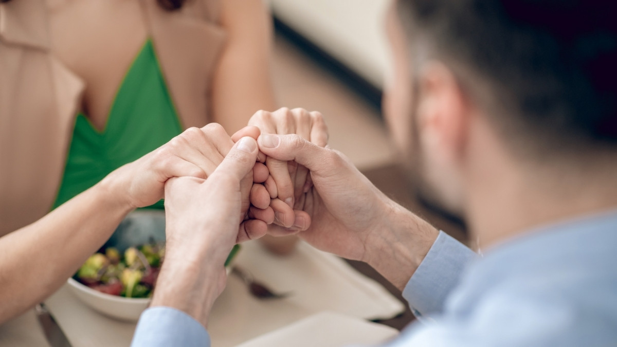 A man and a woman holding hands