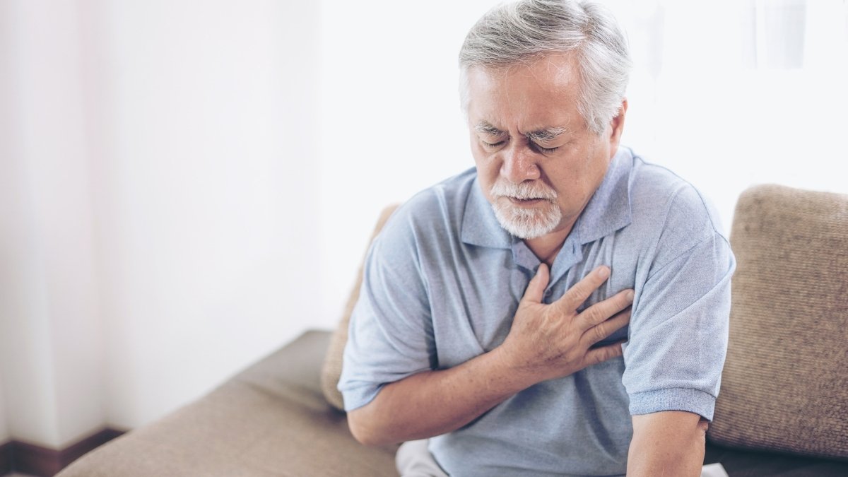 A man suffering from a bad pain in his chest that could be a heart attack