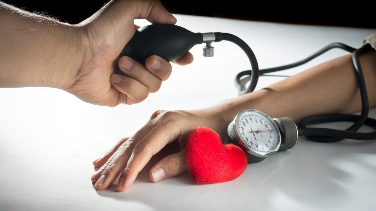 Doctor examining pulse of a patient