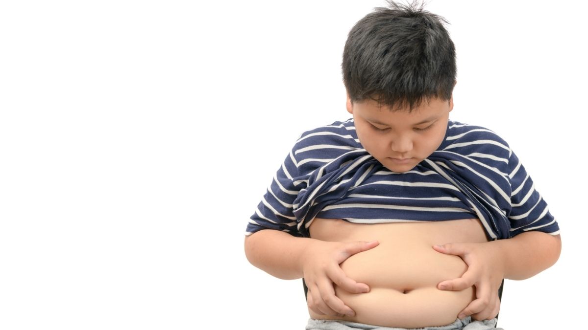 An obese child holding his stomach