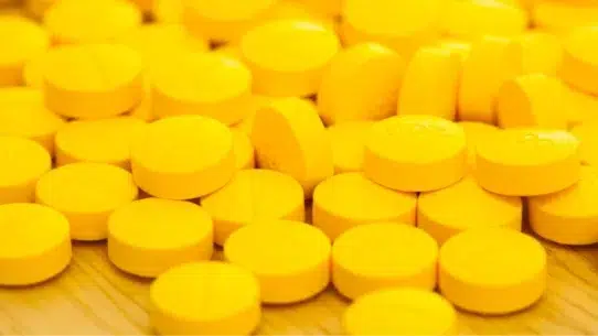 Yellow levitra pills on the floor